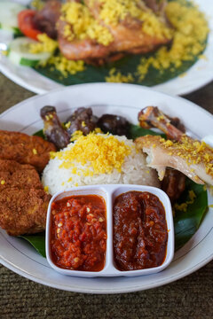 Special fried chicken topped with crispy coconut floss, served with sambal, fresh vegetables, and traditional side dishes in an authentic Indonesian culinary presentation.