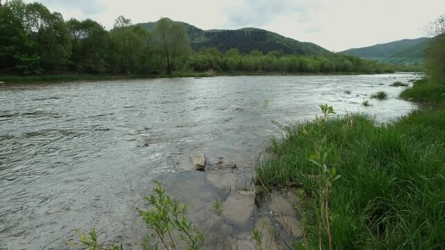 Spring picturesque mountain river band view. (Stryi river near Skhidnytsya village, Carpathians, Ukraine.)
