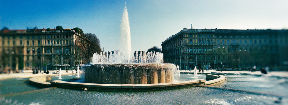 Panoramic view of Fontana di Piazza Castello, a large, scenic fountain located in a public square directly in front of the Sforza Castle (Castello Sforzesco) Milan, Italy, Europe