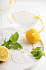Fototapeta premium French 75 cocktails presented with lemon and mint garnish