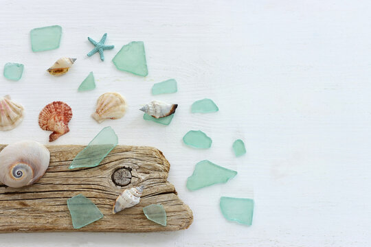 summer background with blue sea glass and shells