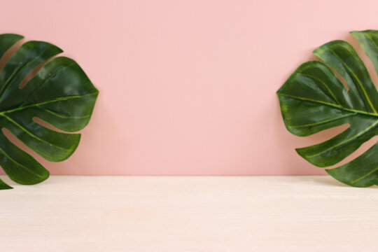 pastel background with leaves and rustic empty table
