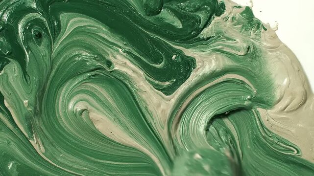 Close-up of a palette knife blending forest green and light beige acrylic paint, creating thick swirling textures and organic patterns, abstract art process,