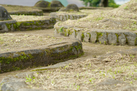 Ancient stone ruins of the banten lama archaeological site in indonesia with mossy volcanic rock structures