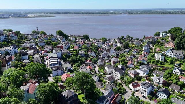 Aerial view of the historic Treppenviertel Blankenese district with white houses on a hillside overlooking the Elbe river and lush greenery in Hamburg, Hamburg, Germany.