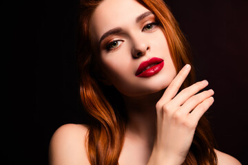 Fototapeta premium Stunning young woman with vibrant red hair posing in elegant lighting showcasing natural beauty and captivating allure