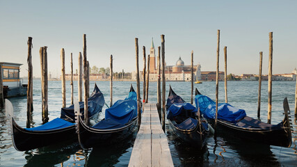 Traditional Gondolas Near Venetian Waterfront, Italy Transport. Italian culture © kohanova1991