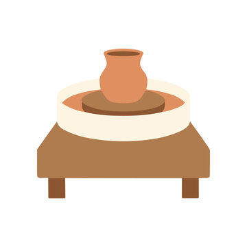 Pottery wheel with clay vase.