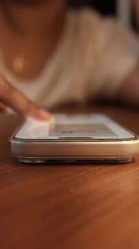 Close-up of a hand scrolling through a social media feed on a smartphone, depicting digital addiction, mindless browsing, and screen dependency in daily life.