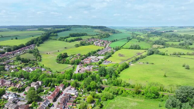 Aerial shot flying over Wiltshire countryside near Wilton towards Grovely Woods. UK