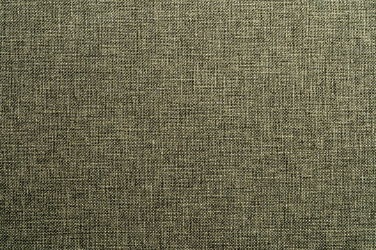 Closeup of textured grey brown or taupe upholstery fabric. High quality seamless style textile background for interior furniture design and fashion clothing concepts