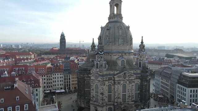 Sunlit rising orbit beside Frauenkirche tower