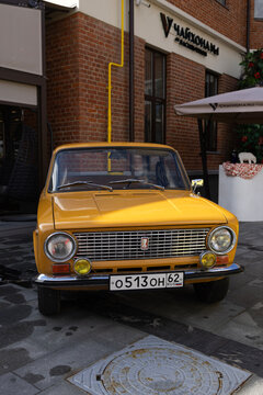 Classic soviet vintage cars lada vaz 2101 on city street exhibition near cafe under blue sky