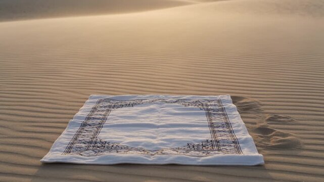 Empty prayer mat on Arafah desert sand glowing in warm sunrise light for symbolic Islamic worship background use