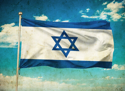 Grunge image of Israel flag waving in the blue sky.