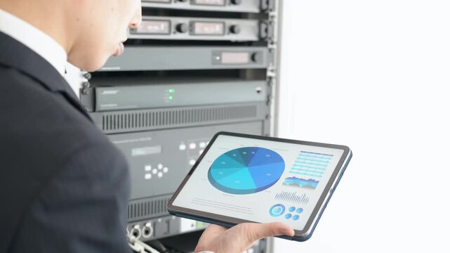 A male engineer inspecting a server.