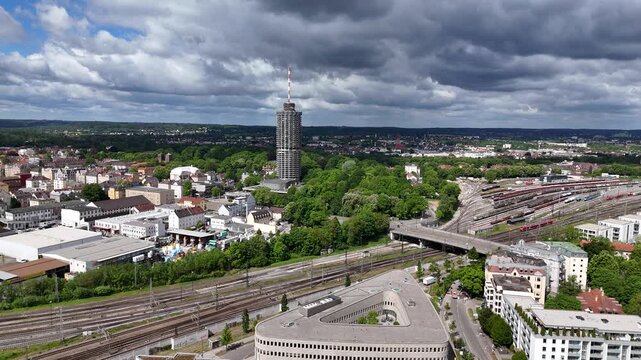 Forward drone flight toward Augsburg Hotelturm and park