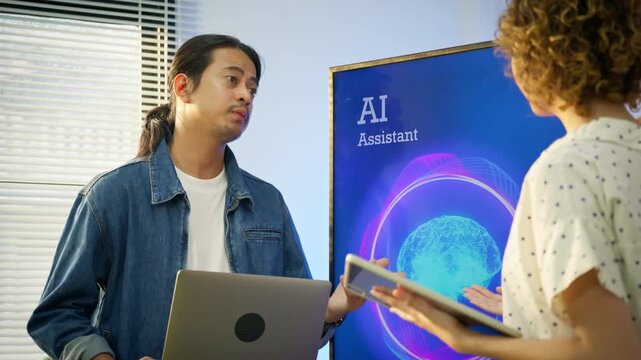 Two developer discusses AI assistant software in modern office. Concept of artificial intelligence product discussion, peer collaboration, software demo, B2B technology meeting, and diverse tech team.