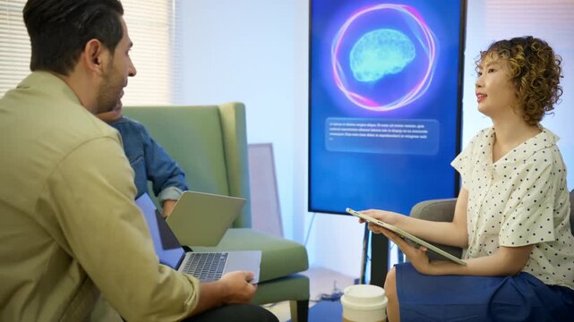 AI engineer holding tablet presents virtual assistant software demo to colleagues on vertical display screen. Concept of AI product launch, business presentation team training in modern startup office