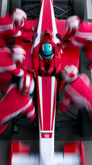 Fototapeta na wymiar Top view of formula race car with pit crew in motion during high speed pit stop service