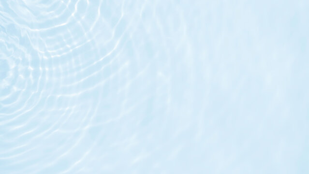 Water ripple background texture with clear blue swimming pool surface, wave pattern, sunlight reflection, and clean liquid backdrop for summer graphic design.