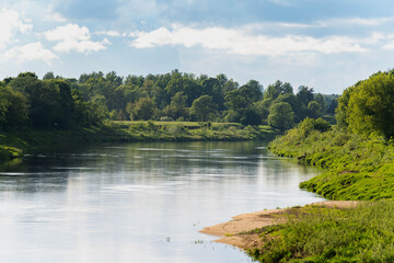 Obraz premium Calm Daugava River with green banks in Latvia