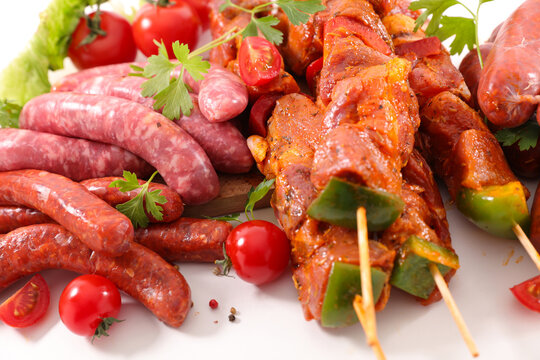 raw bbq meat skewers and sausages assortments