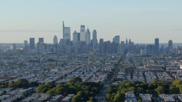 Aerial view of Philadelphia skyline at sunset with city buildings and urban landscape.