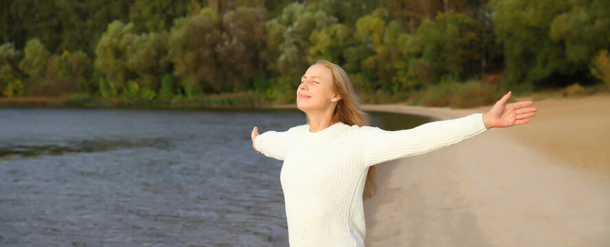 Happy smiling woman on beach, enjoying landscape, warm weather, standing on sea coast