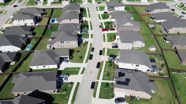 Curved lane home cluster in Arlington, Texas displays fenced yards, small pools patios arranged along winding street shapes suburb neighborhood pattern. Even lighting, uniform roofs green lawns