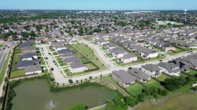 Curved street pattern south of Webb Ferrell Rd, Arlington highlights looping residential roads, fenced yards central pond anchoring subdivision. Repeating rooflines, bright lawns crisp shadows, TX