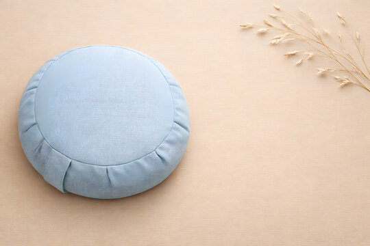 Blue Round Meditation Cushion with Dried Pampas Grass on Beige Background
