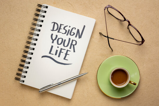 design your life - inspirational handwriting in a spiral notebook with a cup of coffee, planning, career, lifestyle and personal development concept