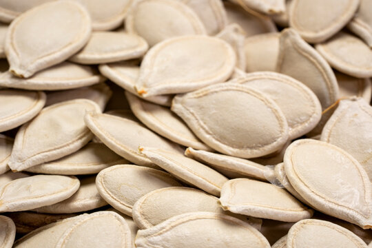 closeup background and texture of raw pumpkin seeds in shells