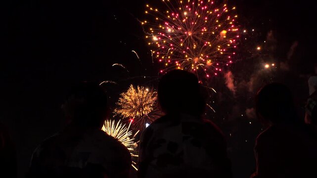 TOKYO, JAPAN - MAY 2026 : View of fireworks and back shot of people. Japanese summer season and festival concept video.