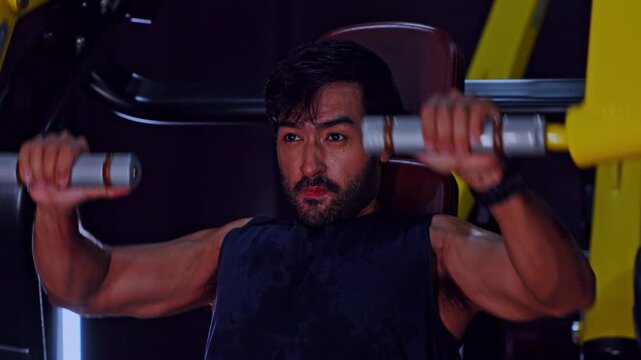 Fitness gym workout strength training chest press man athlete muscular exercise, focused male athlete performing chest press strength training workout machine modern gym, weight machine bodybuilding