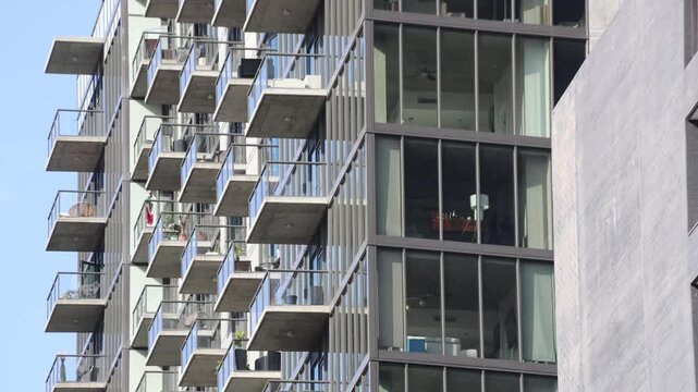 Modern Downtown Apartment Facade With Balconies In Sunlight