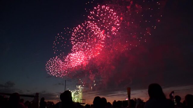 TOKYO, JAPAN - MAY 2026 : View of fireworks and back shot of people. Japanese summer season and festival concept video. Slow motion shot.