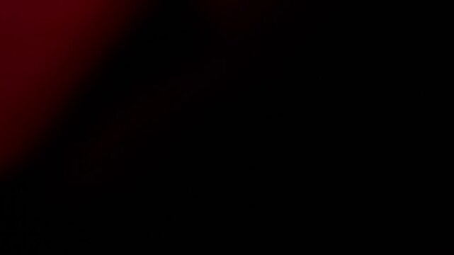 Una toma de cerca de un fondo abstracto de color rojo y negro un degradado ligero desenfocado en movimiento