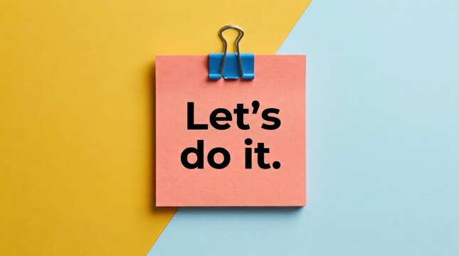 Motivational sticky note with Let's do it text, pink adhesive memo on yellow and blue background, inspirational message for business productivity