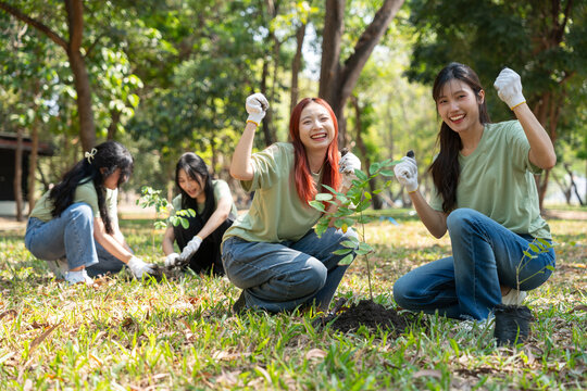 Green Thumbs and Hopeful Hearts: A group of volunteers plant a tree, embodying environmental care and communal action, with the earth under the sun.