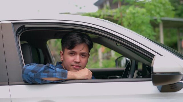 Smiling Driver at Wheel: A confident driver smiles warmly from the car's driver seat, offering a friendly welcome while driving.