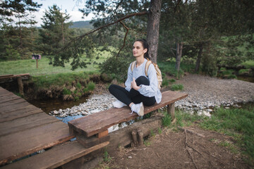 Fototapeta premium Woman relaxing on bench in nature