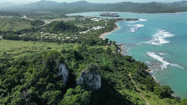 Aerial panorama of Maimon Bay in Puerto Plata, Dominican Republic, featuring turquoise Caribbean waters, tropical coastline, cruise ship harbor and lush green mountains.