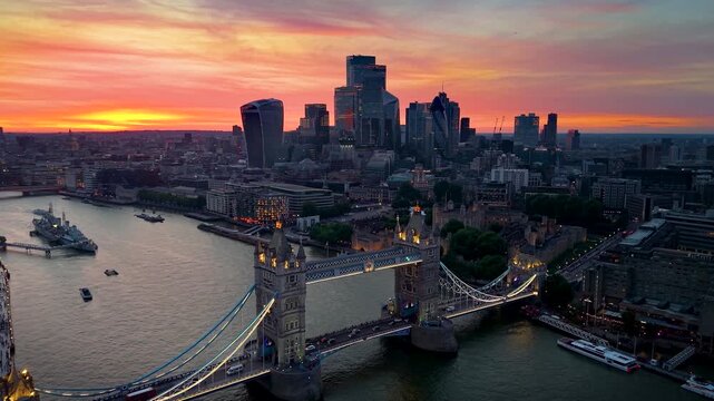 Establishing, aerial summer sunset view of the skyline of London, England, with Tower Bridge and the City skyscrapers