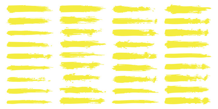 Set of yellow paint brush strokes for artistic design elements isolated on a plain light surface background