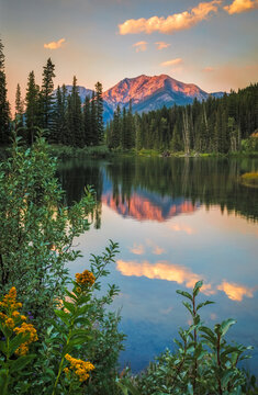 Mount Rundle reflecting in a lake at sunset