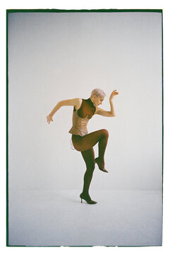 A dancer poses in a studio