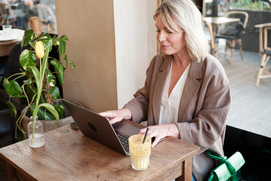 Woman using laptop at a cafe