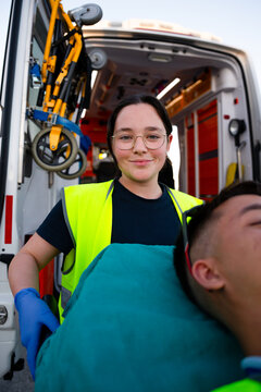 Paramedic transporting patient in ambulance